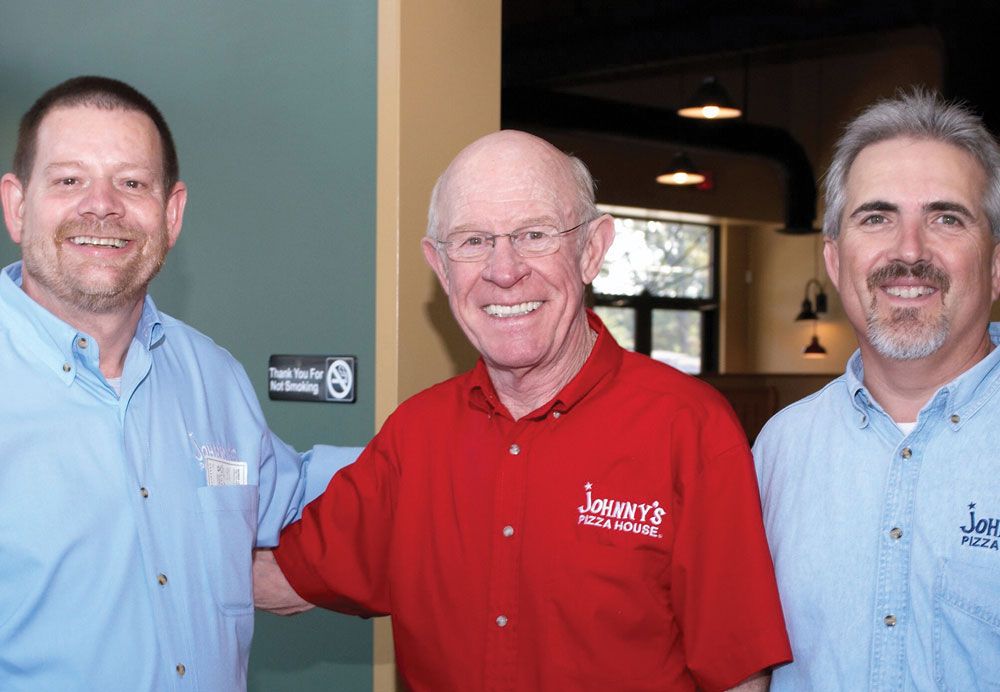 From left: Bernie Lear, chairman of the board at Johnny’s Pizza House; company founder Johnny Huntsman; and Melvin DeLacerda, president and CEO.