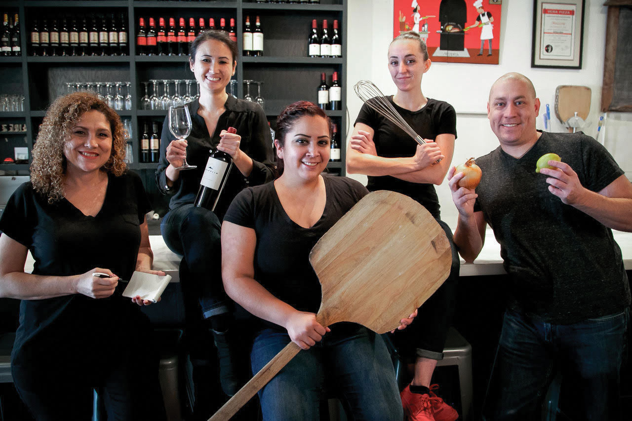 this photo shows the staff, all of whom are deaf, at Mozzeria