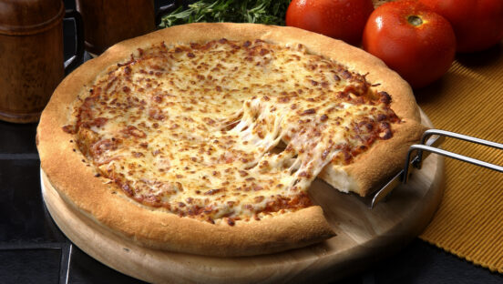 This photo shows a thick-crust Margherita pizza that's heavy on the melted cheese.