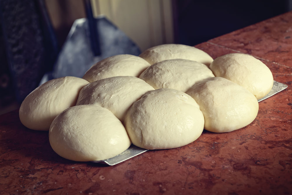 this photo illustrates the importance of getting pizza dough balls into the cooler quickly