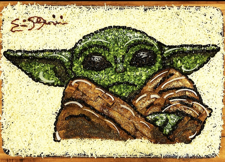 this baby yoda pizza is an example of pizza art by Eric Palmieri