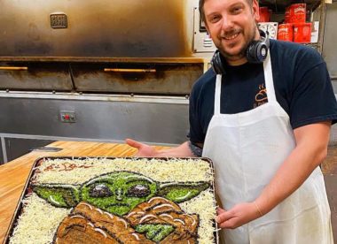 this photo shows Eric Palmieri with his pizza art, a Baby Yoda pizza