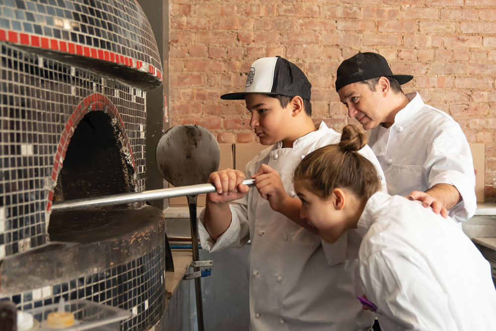 Harlem Pizza Co. owner Alper Uyanik and his two children