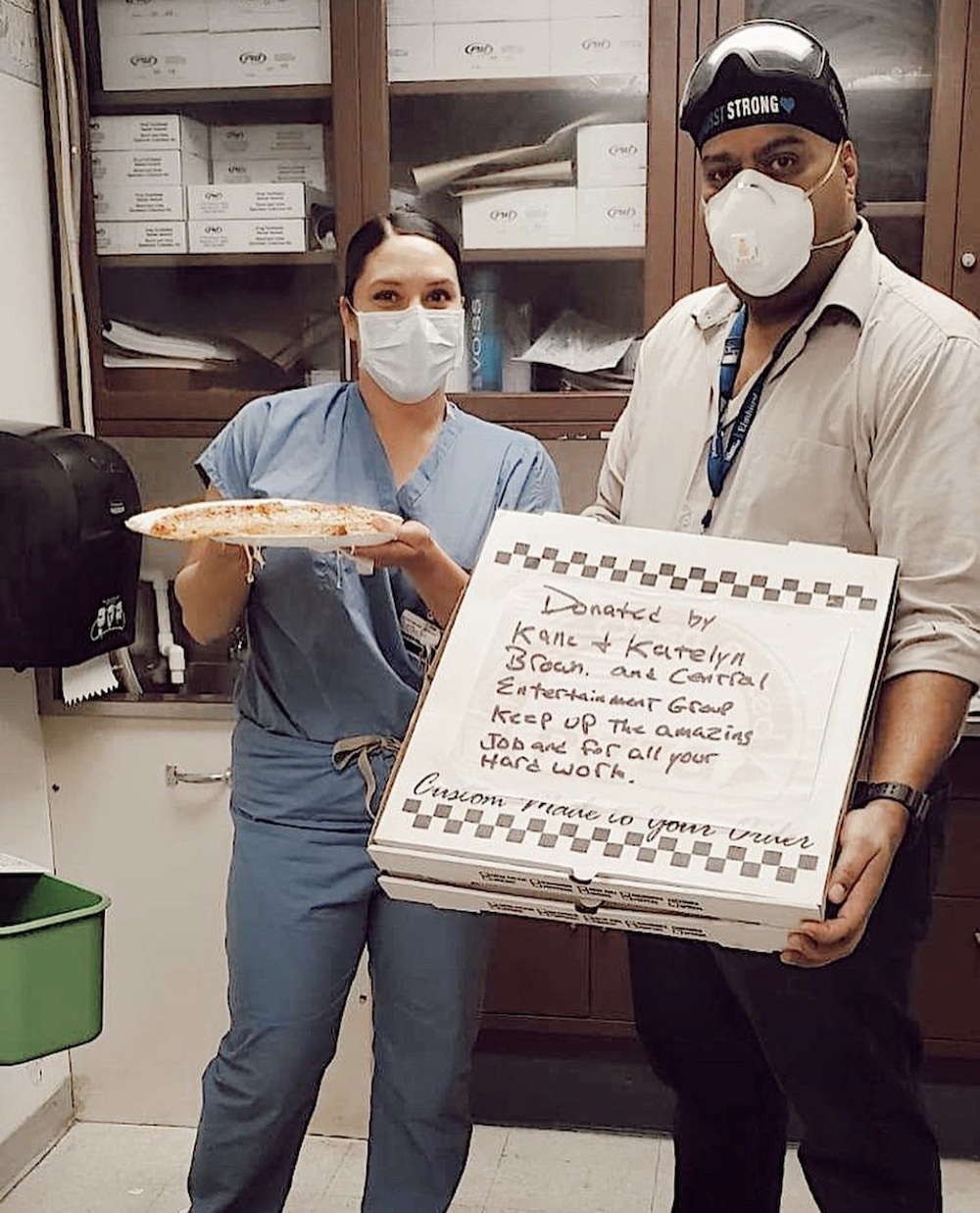 a photo of hospital workers receiving free pizza donated by country music star Kane Brown