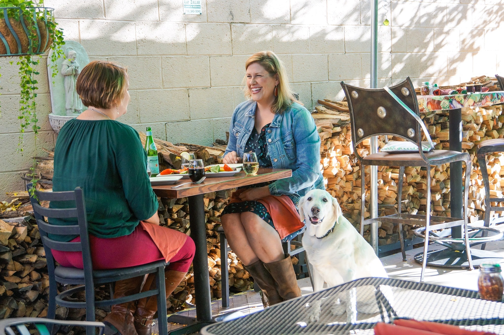 this photos shows two women dining outdoors at Pizzeria Rustica