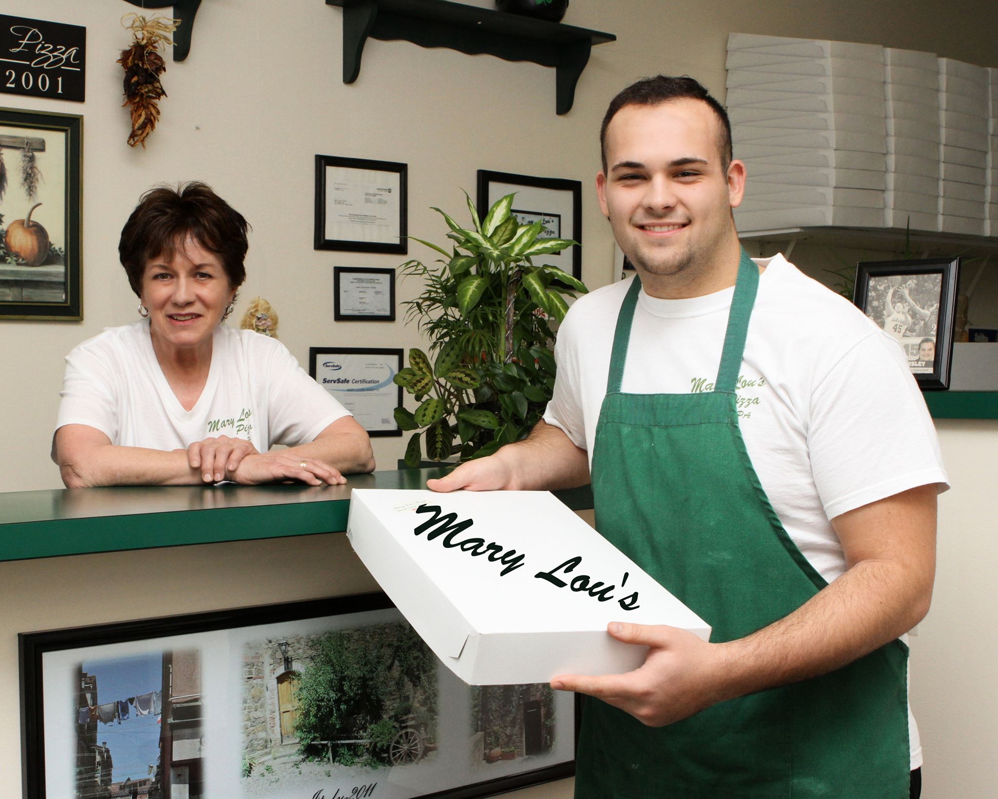 this photo shows the owner and an employee of Mary Lou's Pizza, an Old Forge-style pizza shop in Lackawanna County, Pennsylvania