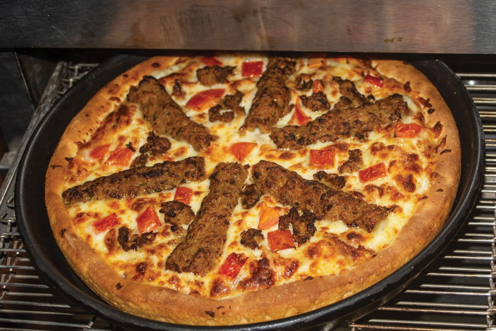this photo shows a delicious pizza made in a conveyor oven