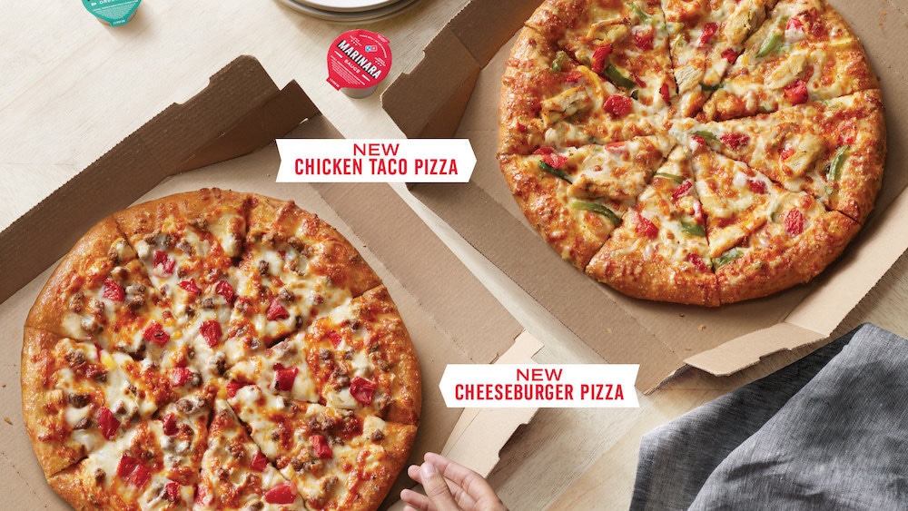 this photo shows the new cheeseburger pizza and taco chicken pizza from Domino's