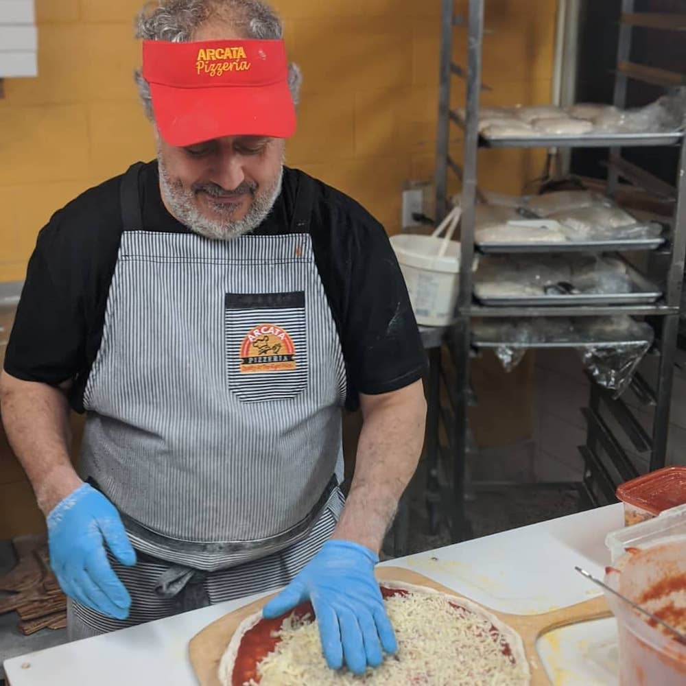 this photo shows Bob Abumeeiz, owner of Arcata Pizzeria, prepping a Windsor-style pizza.