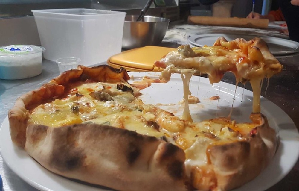 this is a photo of a pizza that set a Guinness World Record for most varieties of cheese on a pizza