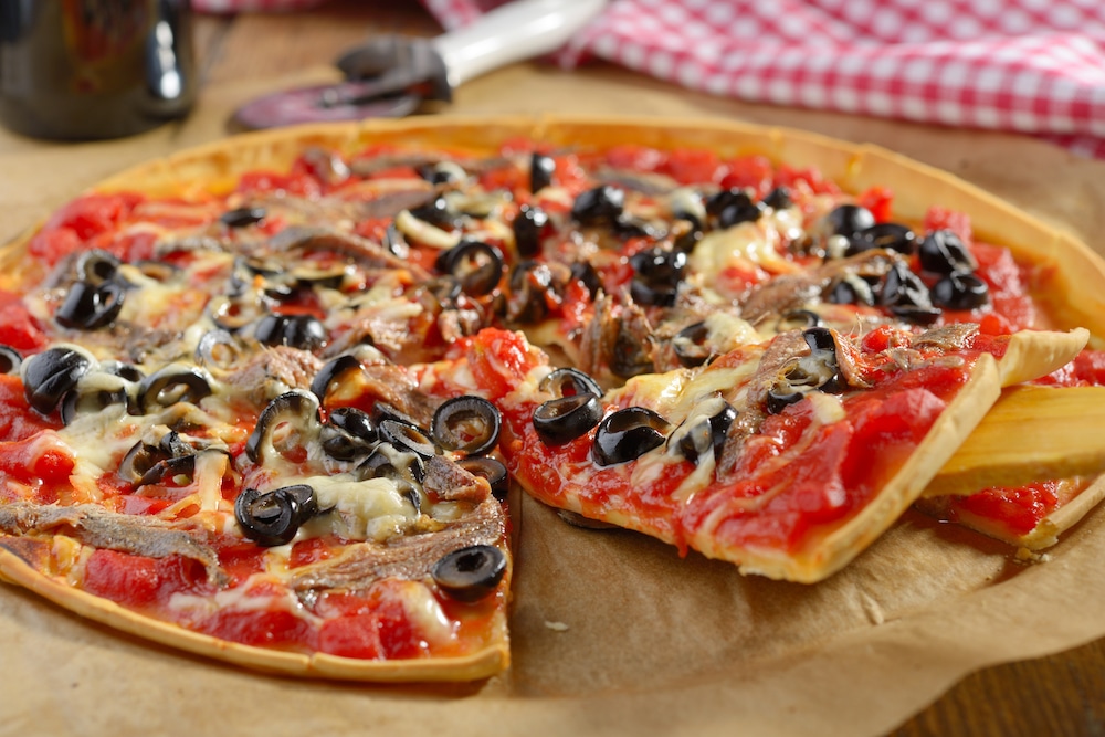 this is a photo of a pizza with the least popular pizza topping- anchovies