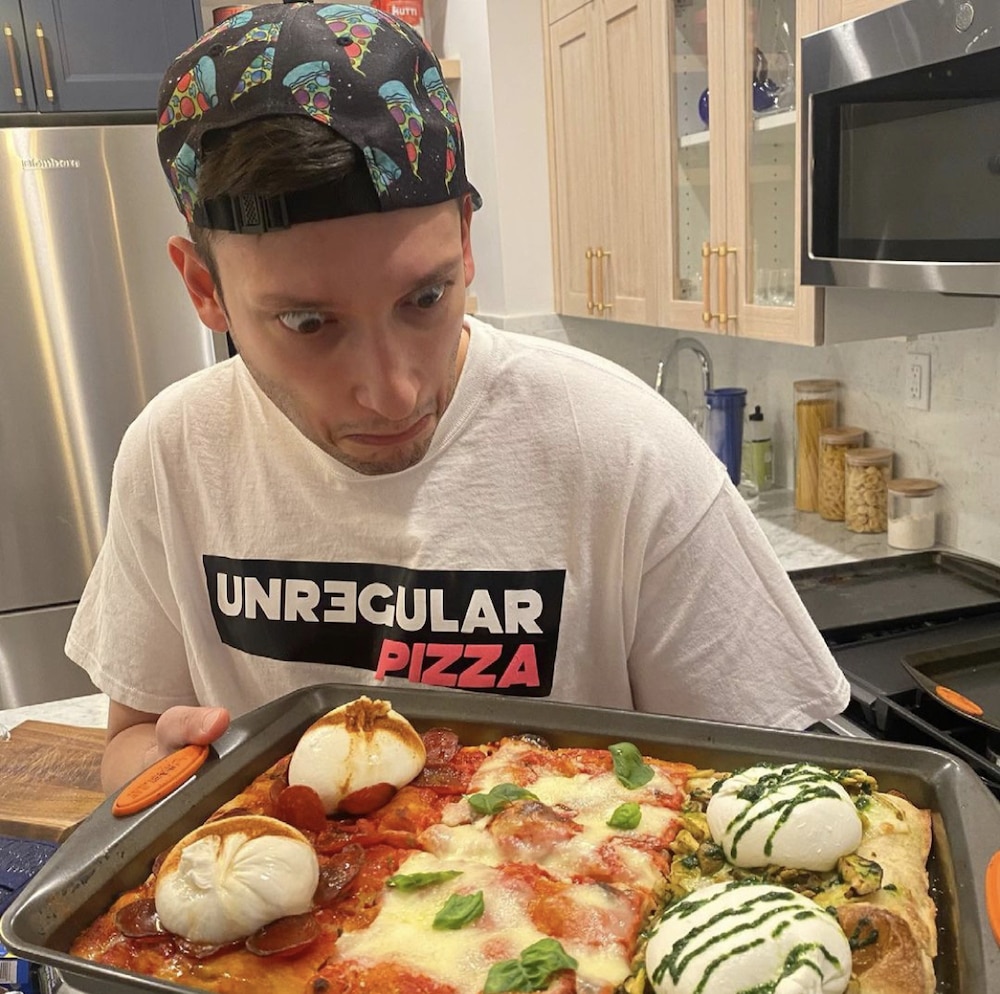 this photo shows Gabriele Lamonaca of Unregular Pizza staring in amazement at one of his unique pizza creations