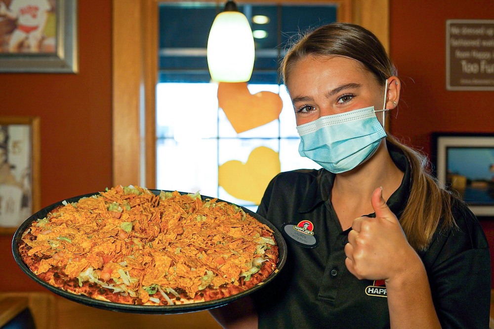 this photo shows an attractive female server at Happy Joe's Pizza and Ice Cream