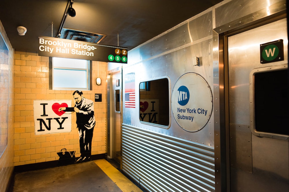 this photo shows the New York subway-themed bathroom at Two Cities Pizza