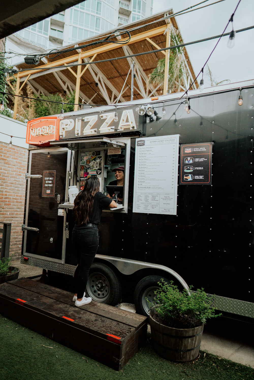 this photo shows a customer ordering from a Via 313 food trailer in Austin, Texas