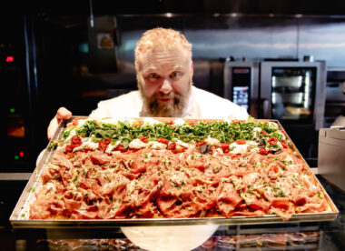 this photo shows renowned pizza chef Gabriele Bonci with a Roman-style pizza.
