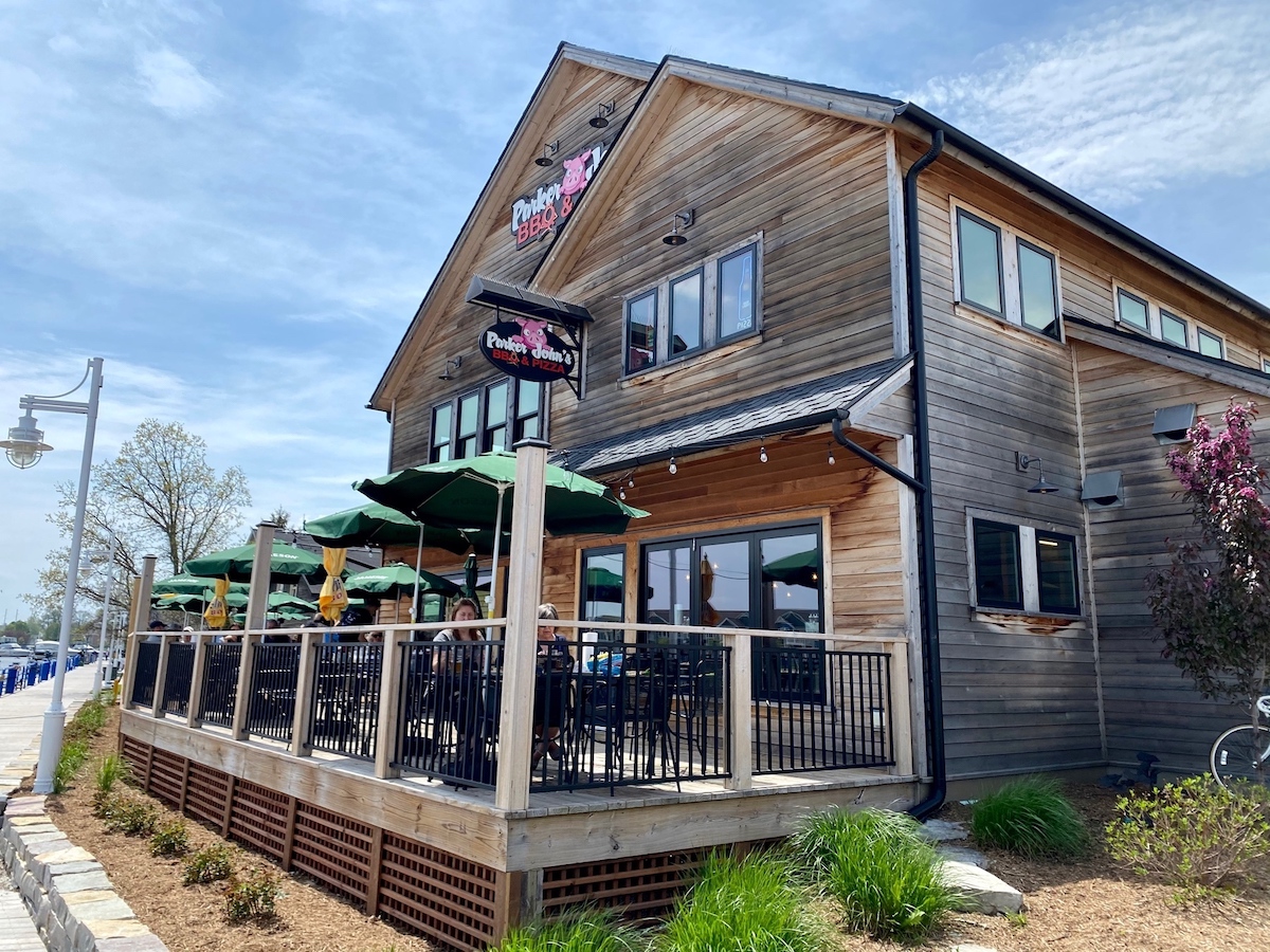 this photo shows the rustic exterior of a two-story location of Parker John's BBQ and Pizza