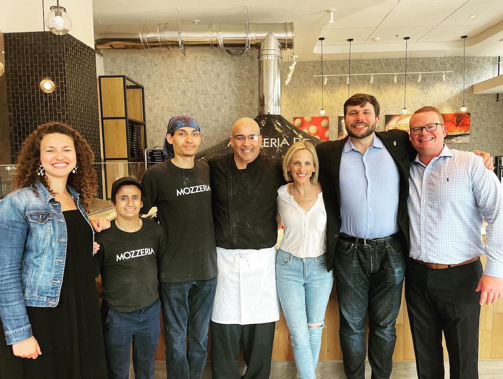 this photo shows a group of men and women in the Mozzeria restaurant, including actress Marlee Matlin.