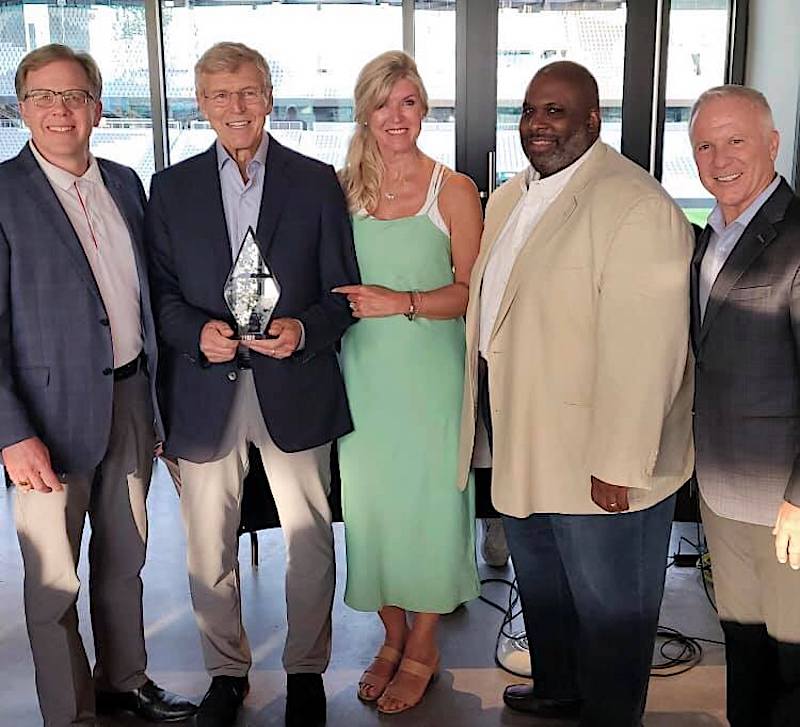 here we see a group of people standing together, including Jim Grote next to Jane Grote Abell. Jim is holding an award from the Ohio Restaurant Association.