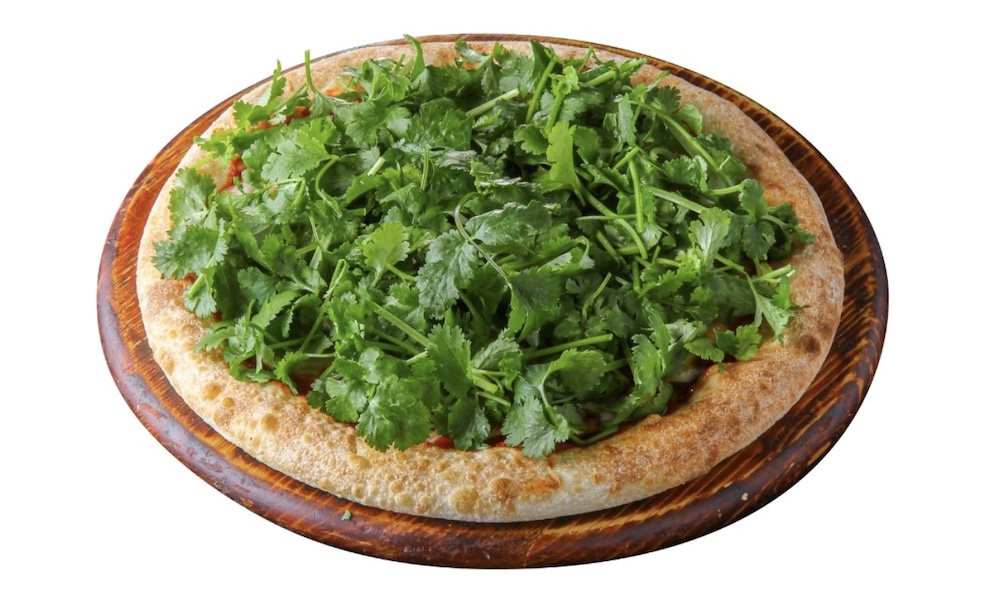 Here we've got a pizza that's piled high with cilantro leaves