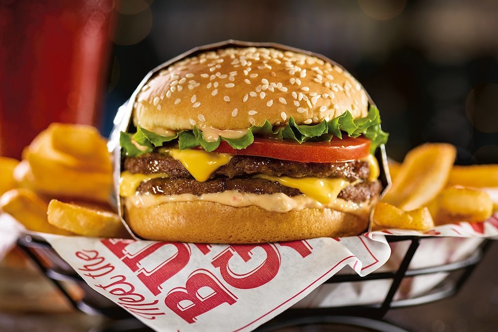 this photo shows the Tavern Burger and a side order of French fries on a Red Robin-logoed napkin