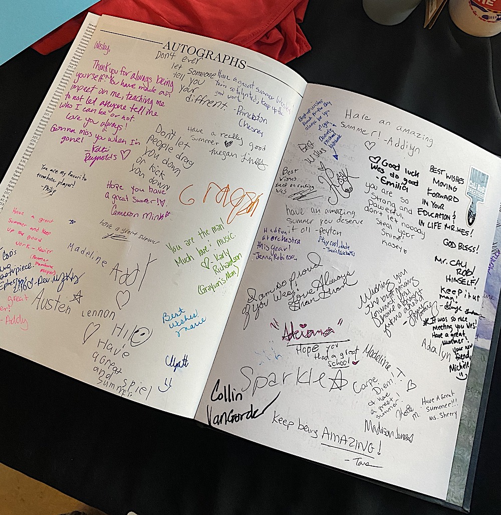 this photo shows two pages of Wes's yearbook with at least two dozen signatures