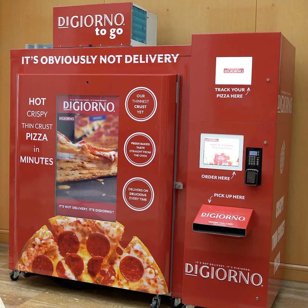 This photo shows the DiGiorno To Go pizza vending machine, a large red kiosk.