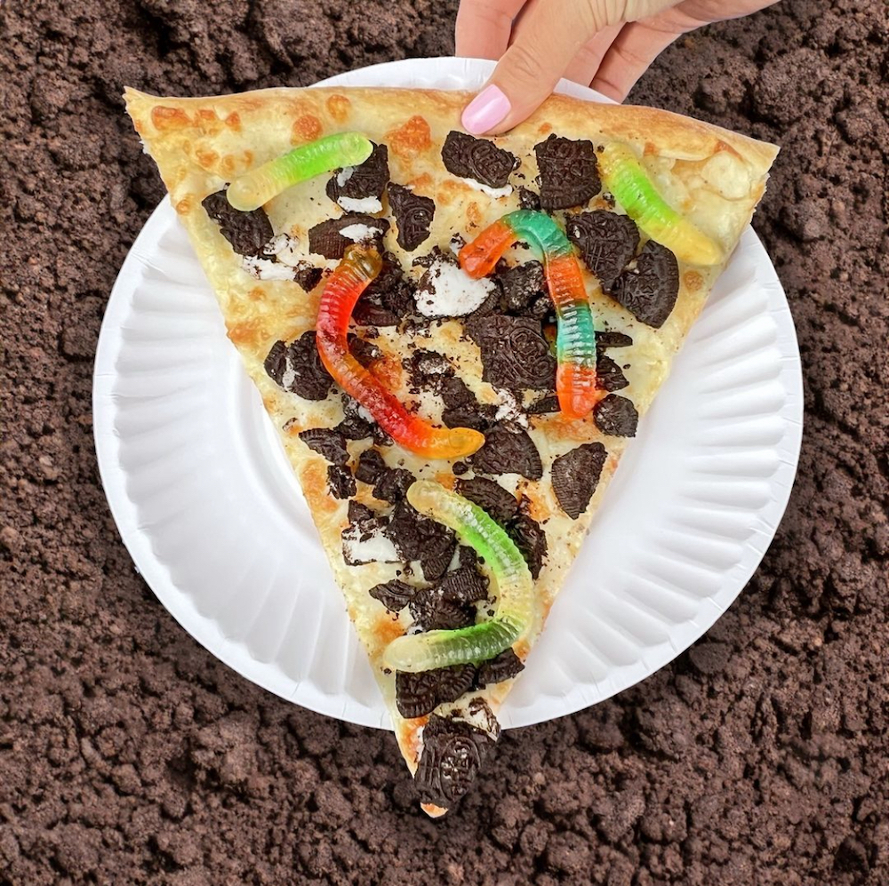 This photo shows one of Cam's Pizzeria's crazy slices, this one topped with gummy worms and crumbled cookies.
