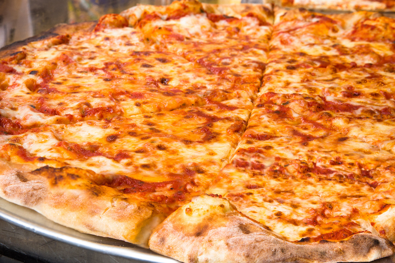 This photo shows a classic thin-crust New York-style pizza topped with cheese