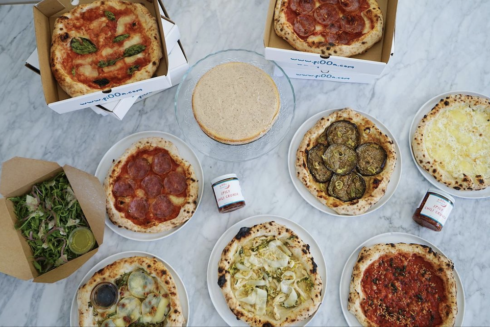 Photo shows an array of mouth-watering pizzas, including Asian fusion pies.