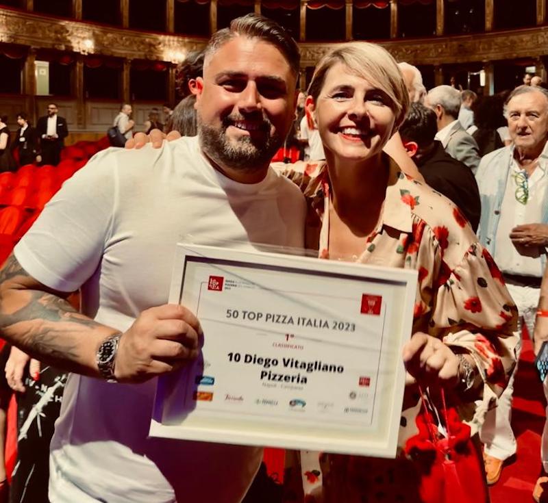 This shows Diego Vitagliano with a woman (perhaps his wife) holding his 50 Top Pizza certificate at the awards ceremony