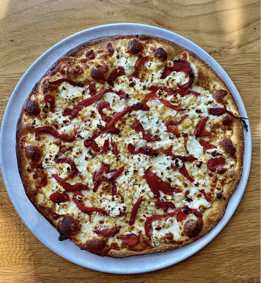 A photo of a pizza from Little Star Pizza in San Francisco featuring Calabrian Chili Peppers.