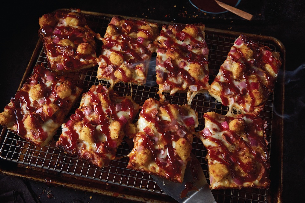 This photo shows slices of the Popcorn BBQ Chicken Pizza.