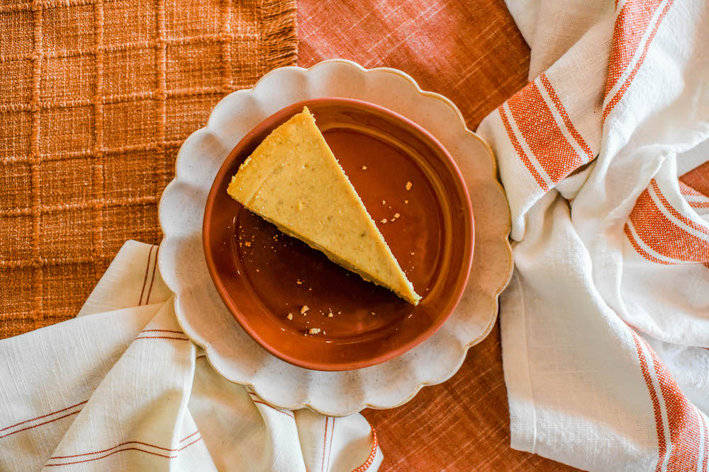 Photo shows a tempting slice of pumpkin cheesecake.