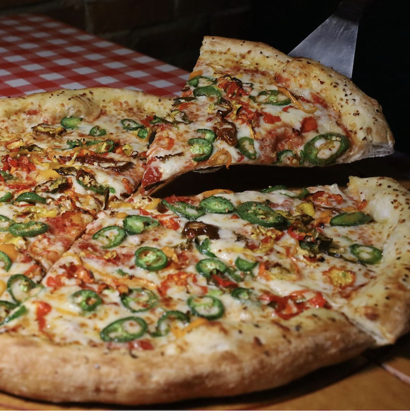 This photo shows the Fiery Death pizza topped with various hot peppers