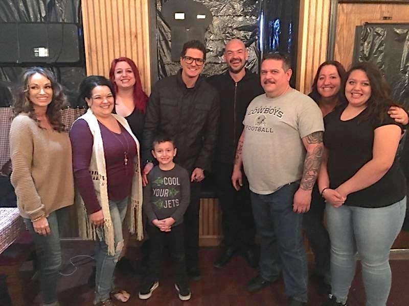 This photo shows the Randazzo family with Zak Bagans and other team members of Ghost Adventures