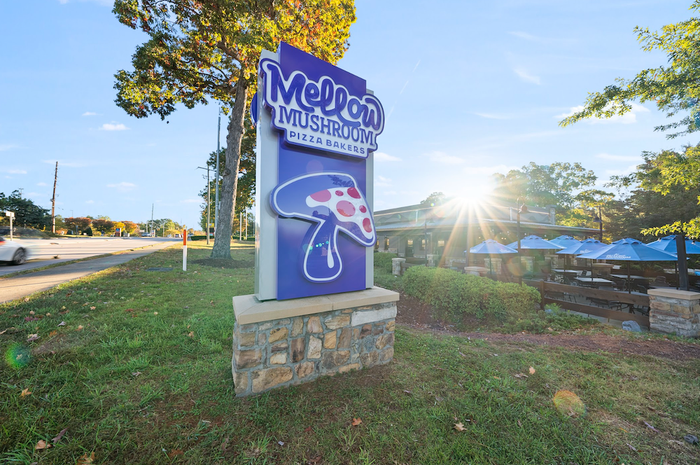 A Mellow Mushroom sign outside of a Mellow Mushroom location. The brand is going through a refresh.