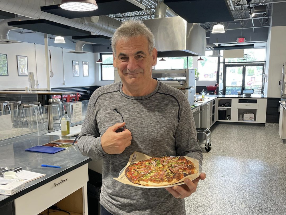 Jim Cervone, owner of CRUST in Pittsfield, Massachusetts, shows off one of his pies.