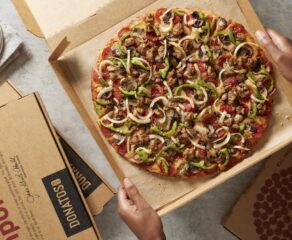 This photo shows a thin-crust Donatos Pizza topped with sauce, smoked, Provolone and, Romano cheese, pepperoni, sausage, mushrooms, green, peppers and onions.