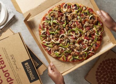 This photo shows a thin-crust Donatos Pizza topped with sauce, smoked, Provolone and, Romano cheese, pepperoni, sausage, mushrooms, green, peppers and onions.