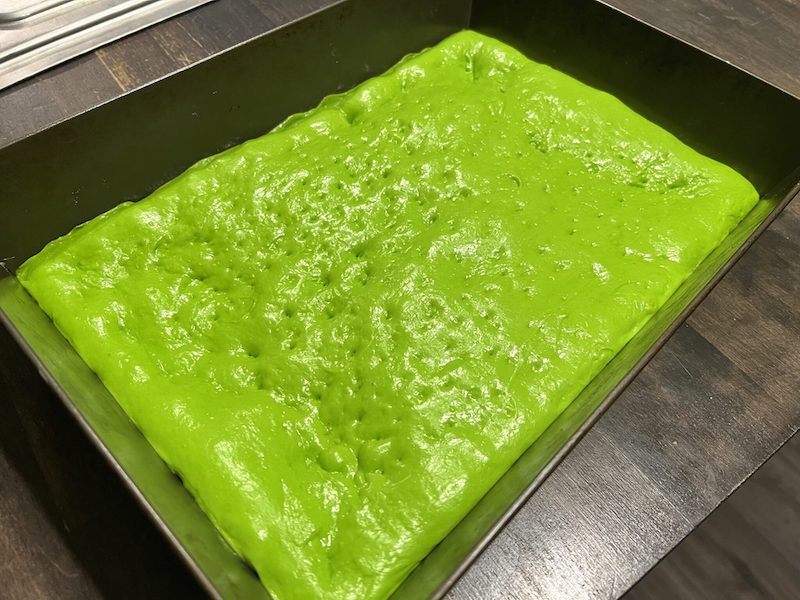 This photo shows the neon-green dough for the Grinch Philly Tomato Pie