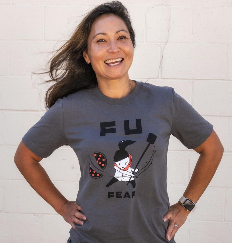 This photo shows Ann Kim wearing a Pizzeria Lola t-shirt with a slogan that reads FU Fear.