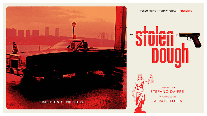 This photo shows a movie poster for "Stolen Dough." It depicts a man driving a vintage car with the top down on the left, while the right shows the Stolen Dough logo, including a pistol firing a bullet through the word "Stolen," as well as the iconic figure of a woman holding scales and a sword as the embodiment of justice.