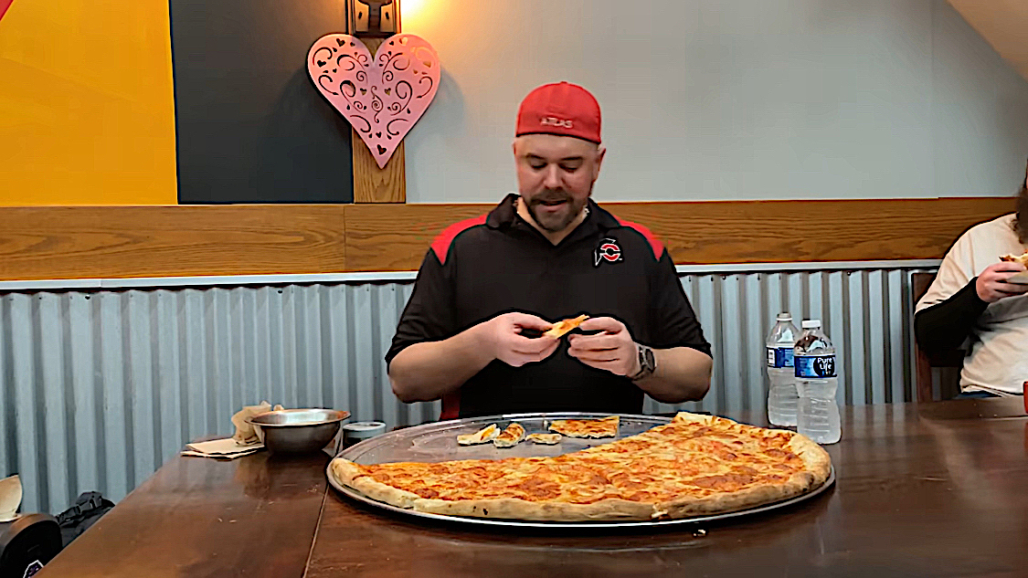 This photo shows professional eater Randy Santel eating a 28-inch pizza at Benny DiCarta's in Kalamazoo, Michigan.