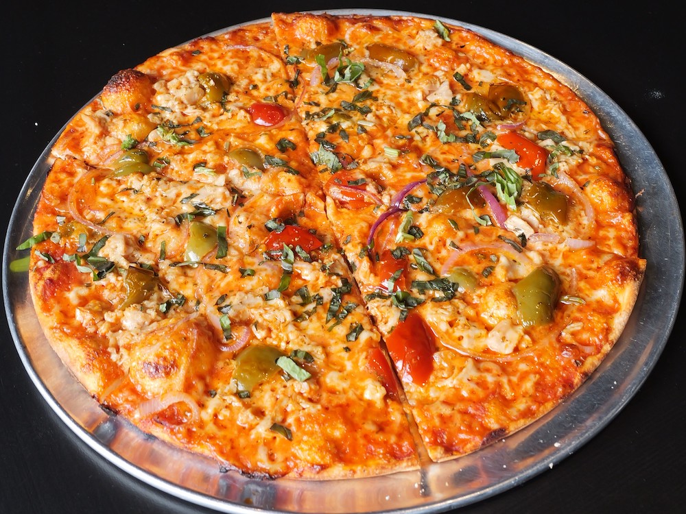 This photo shows a pizza topped with clams, hot cherry peppers and red onions.