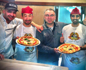 This photo shows Yousef AlHussan on the far right, holding a Margherita pizza, along with David Bruno, a Japanese pizza student named Ryu (who's also holding a pizza) and Enzo Coccial.