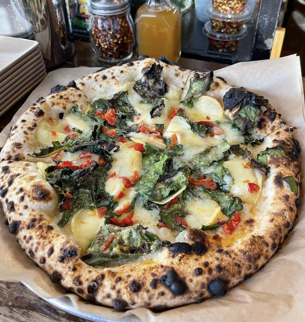 A Neapolitan pizza with veggies atop it from the Denver pizzeria Cart-Rider.