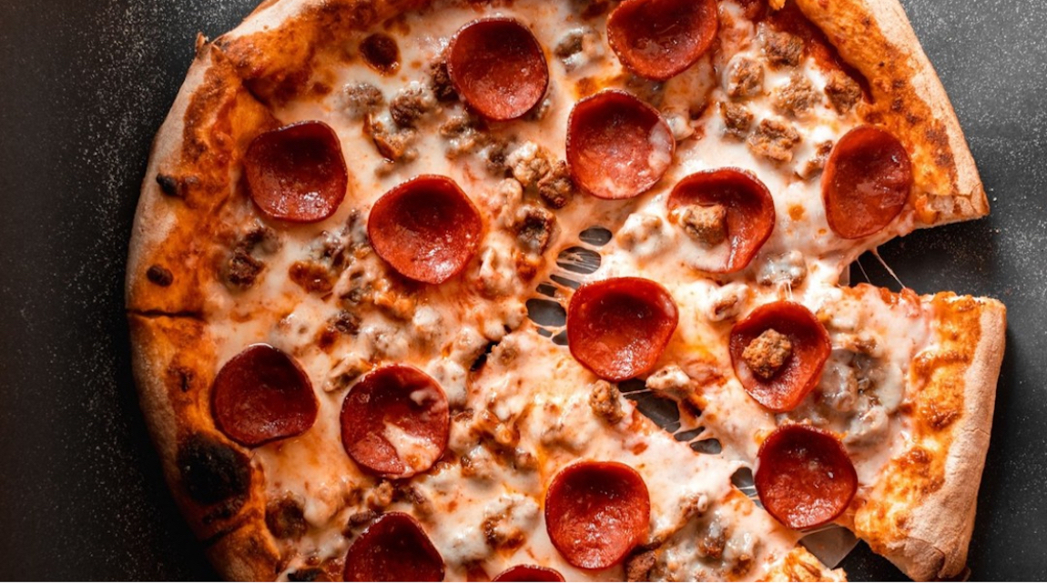 This photo shows a beautiful pepperoni and sausage pizza.