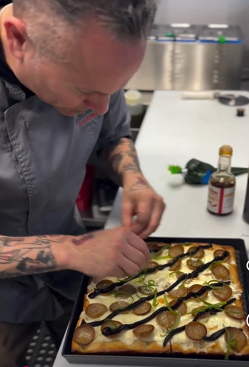 This screen shot of a video shows Tony Gemignani making the Vampire Killer pizza.