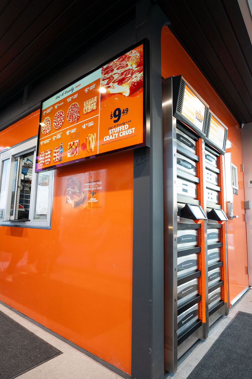 The interior of a new Little Caesars prototype, featuring pick-up lockers and flatscreens.